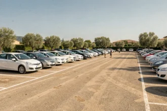 Vue panoramique d'un grand parking de voitures d'occasion dans le Var sous un ciel méditerranéen